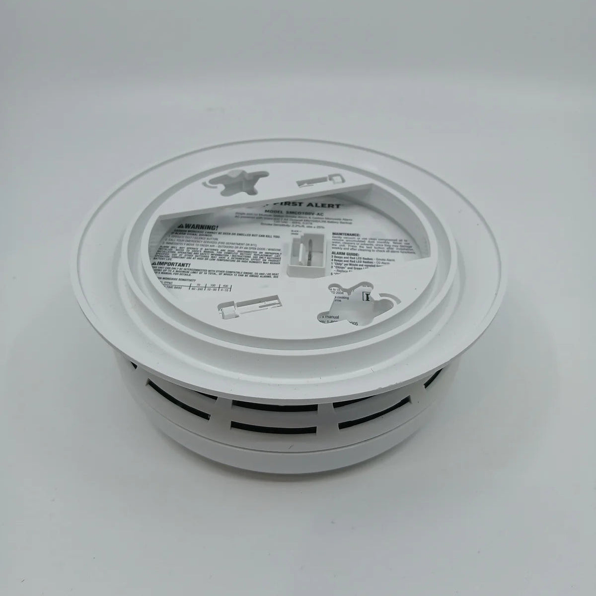BRK SMCO100V-AC hardwired smoke and carbon monoxide detector with interconnected alarm system, mounted on ceiling.