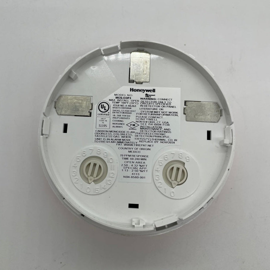 Gamewell-FCI MCS-COF3 smoke and carbon monoxide detector showing the device with sensor and alert indicators.