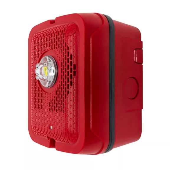 Outdoor LED speaker strobe light by System Sensor, with bright LED and speaker components, mounted on a building exterior.