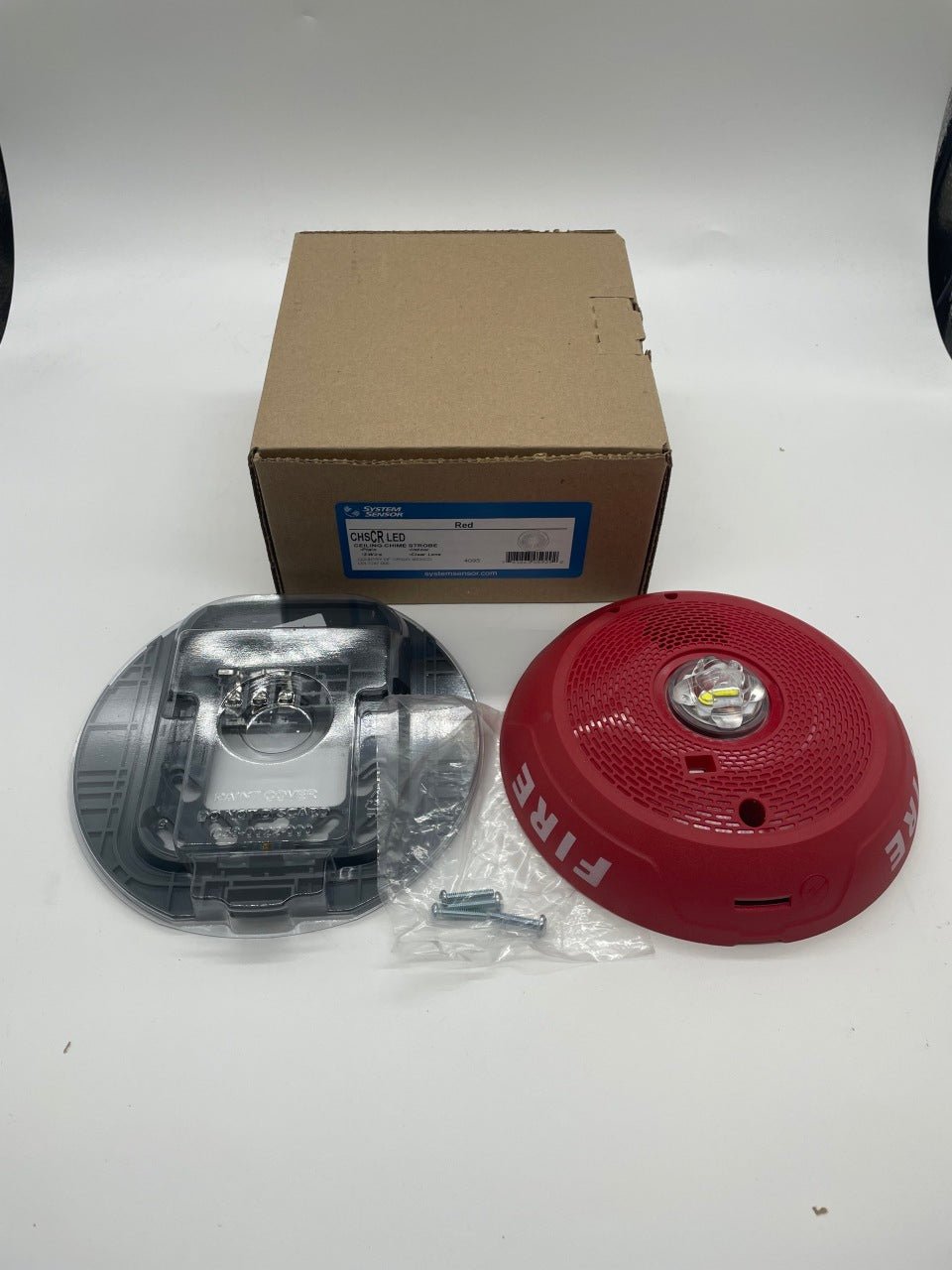 Red System Sensor CHSCRLED chime strobe alarm with integrated LED light and audible alert for fire safety and notification.