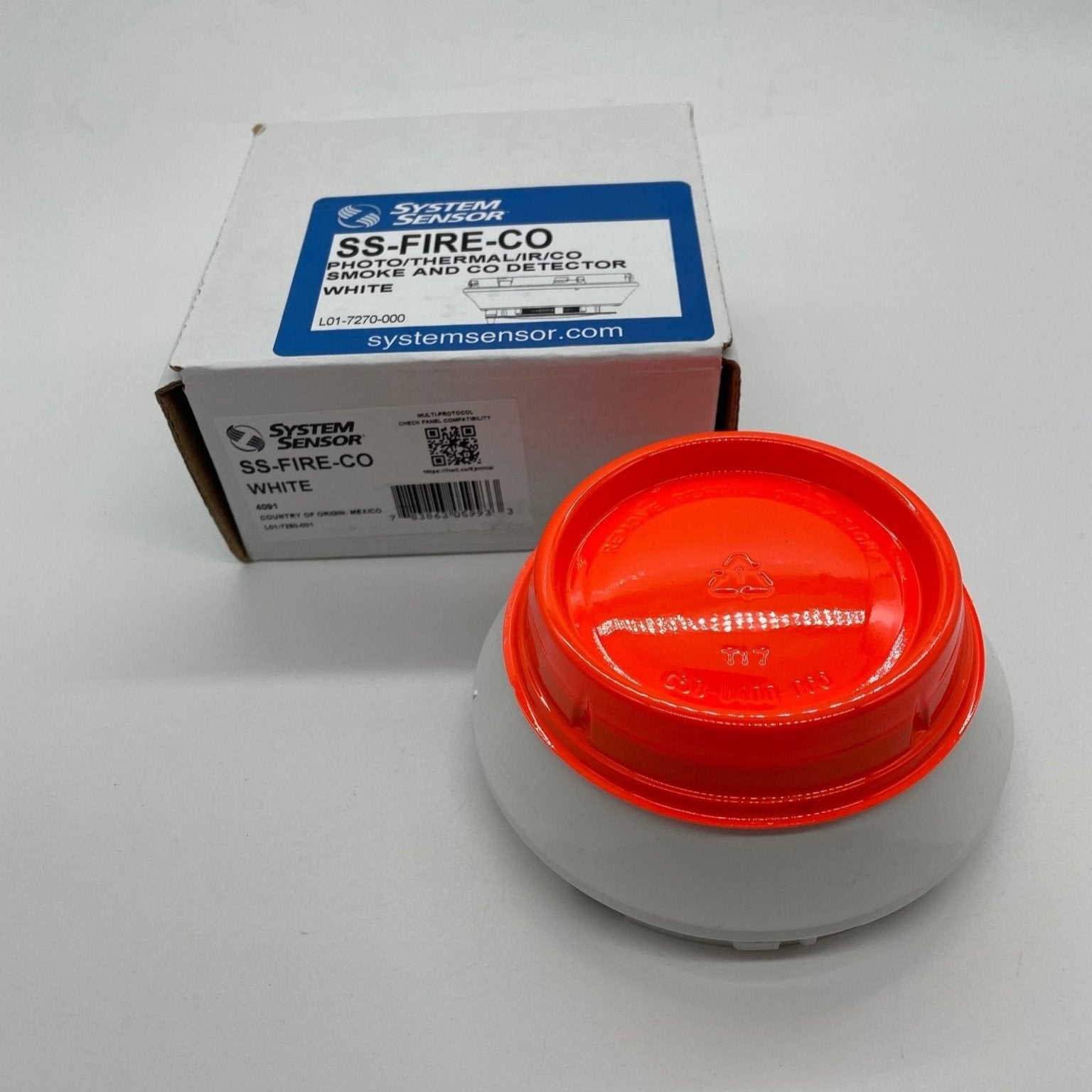 System Sensor SS-FIRE-CO multi-criteria fire and carbon monoxide detector installed on ceiling, detects smoke and CO for safety.