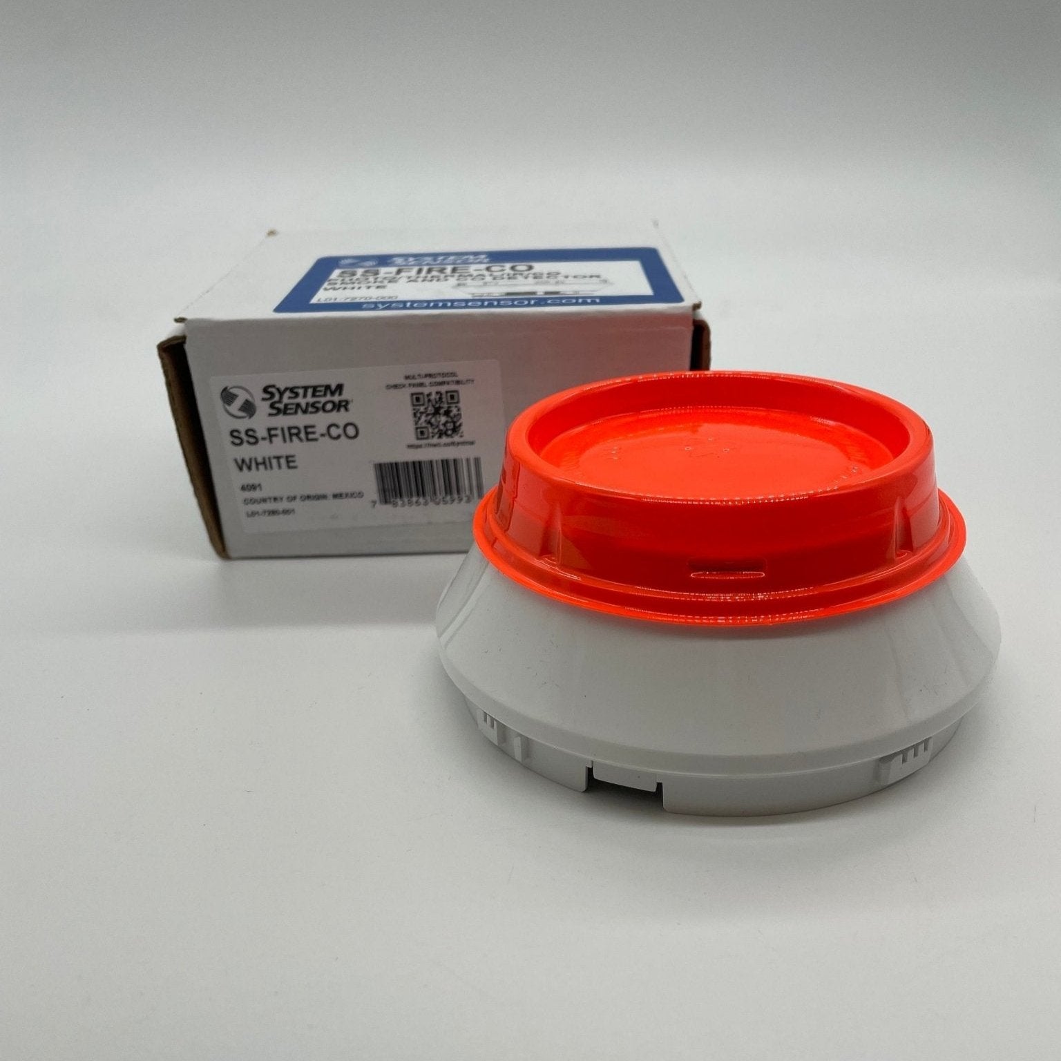 System Sensor SS-FIRE-CO multi-criteria smoke and carbon monoxide detector mounted on a ceiling, with digital display visible.