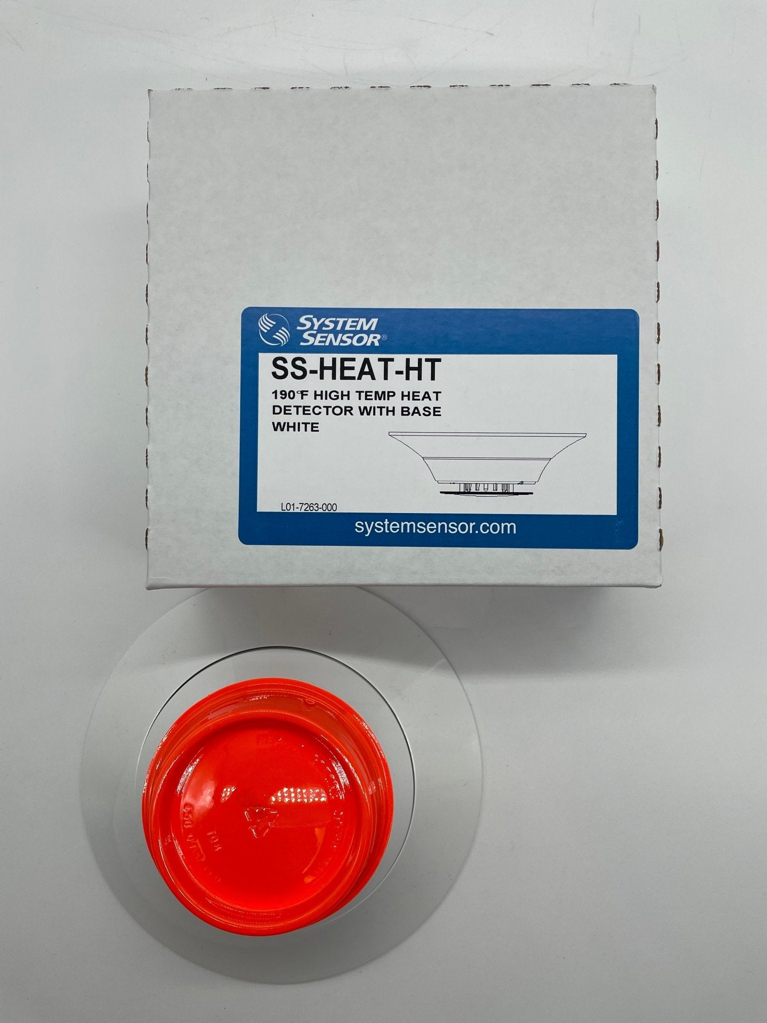 System Sensor SS-HEAT-HT thermal detector showing a compact, black sensor with mounting bracket for heating system safety detection.