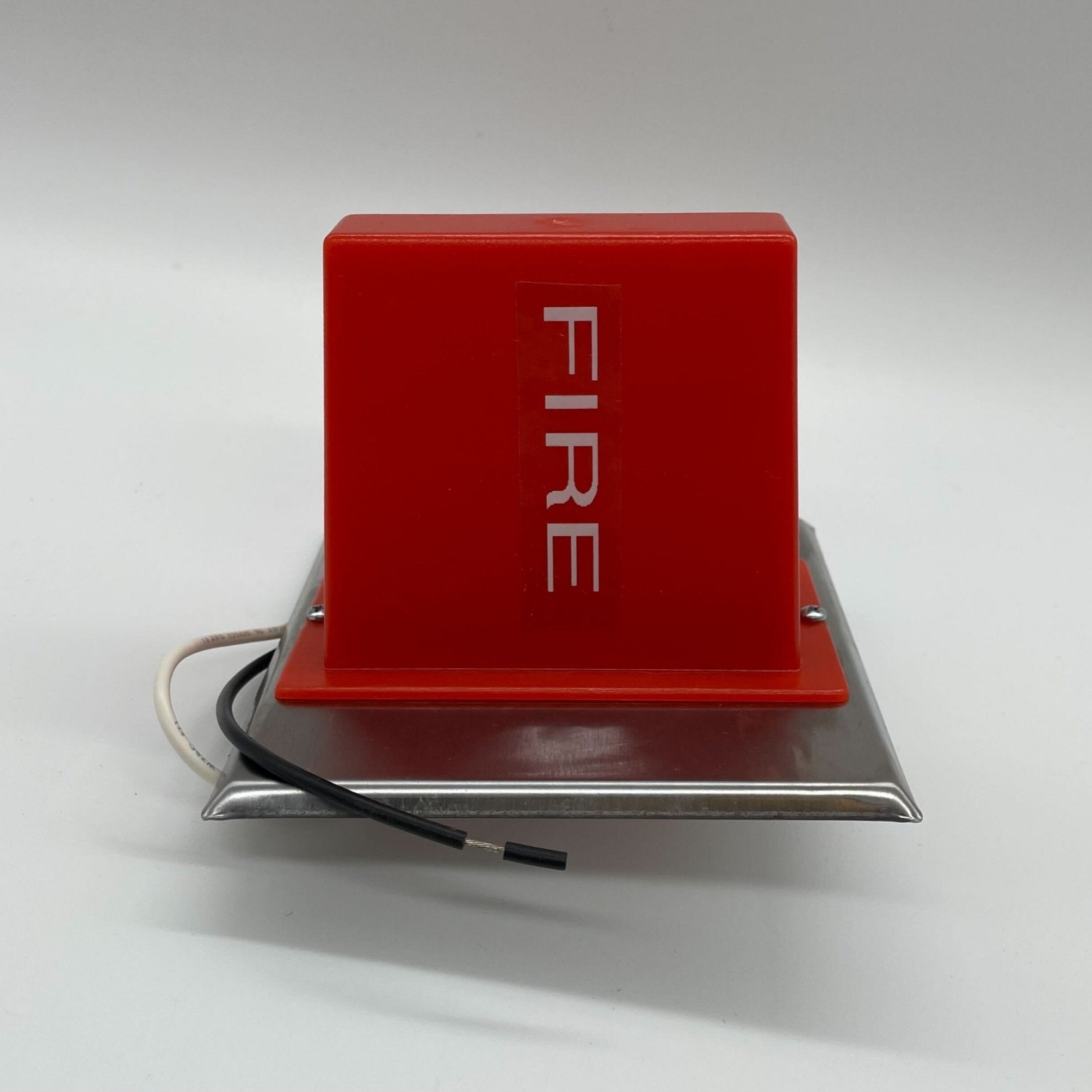 Edwards 890RDA Lamp Station fire alarm with red warning light and control buttons, mounted on wall for emergency signaling.