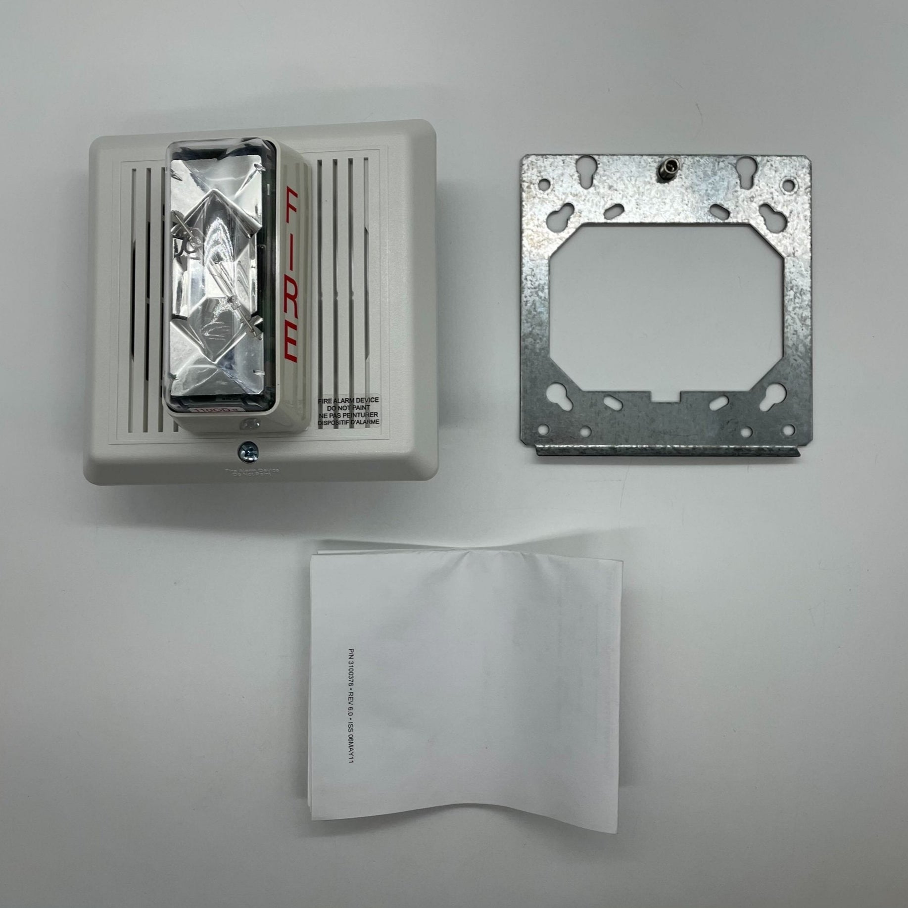 Edwards 757-8A-TW temporal horn strobe with 110 cd luminous output, mounted on a wall, for fire alarm notification.