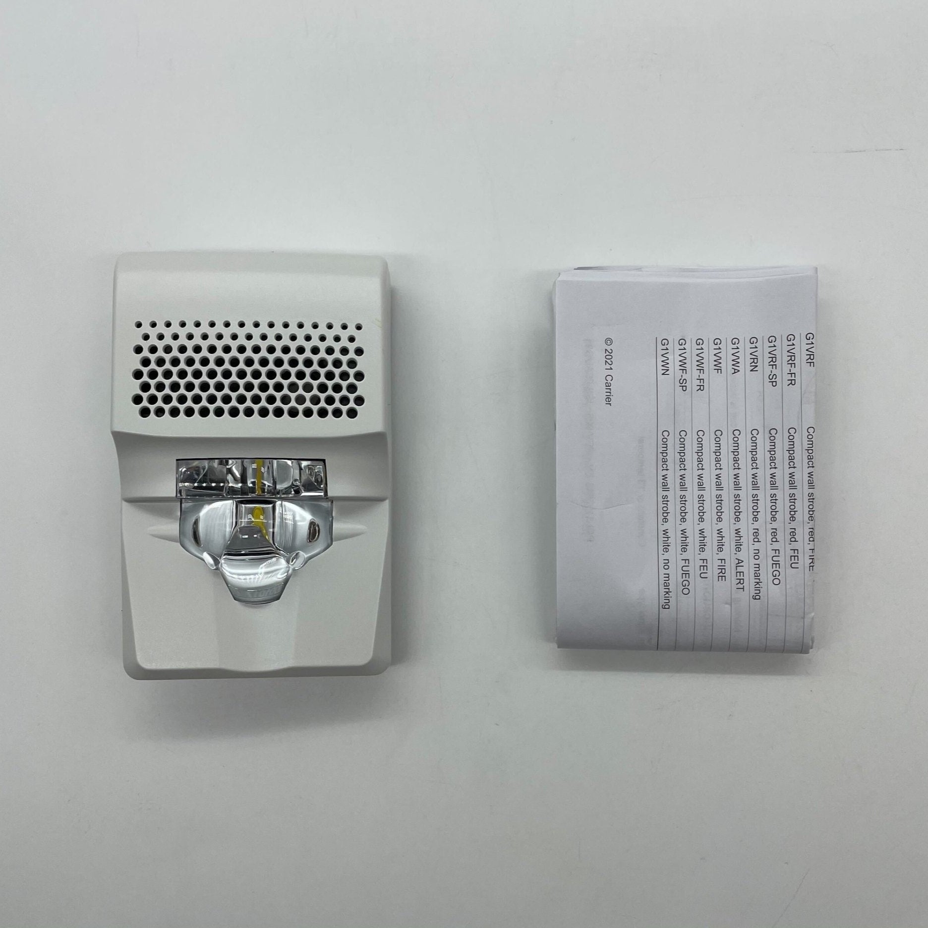 Edwards G1AVWN compact wall horn strobe mounted on wall, emergency alarm device with horn and flashing strobe light