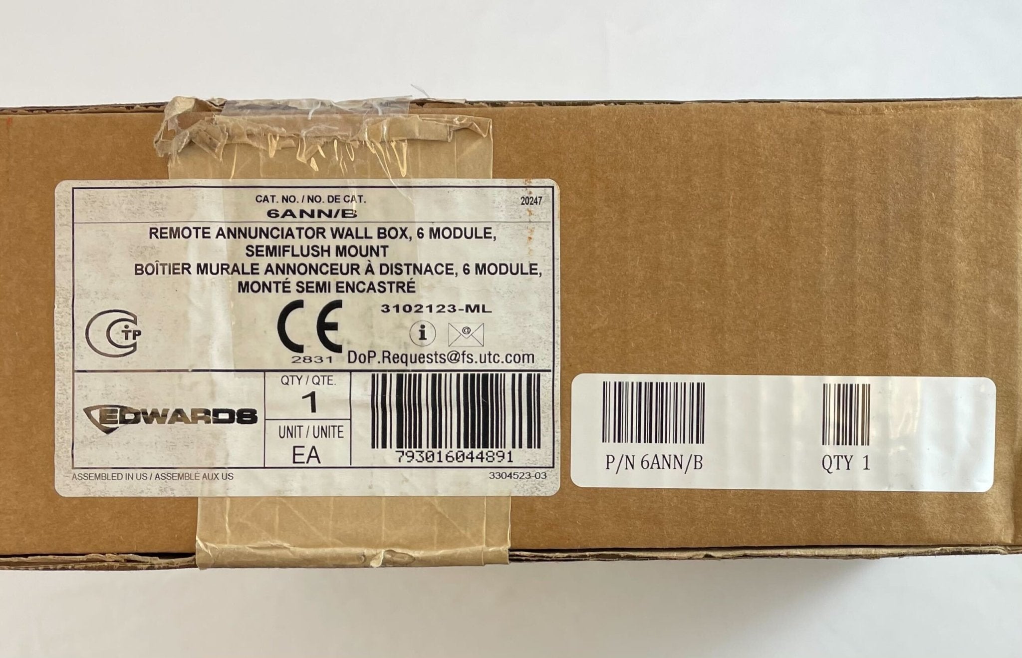Edwards 6ANN/B six-position LED/LCD wall box for electrical control and monitoring, mounted on a wall with visible wiring and display.