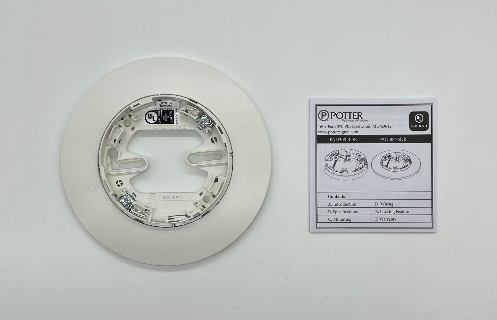 Potter PAD300-6DB 6-inch detector base showing a sturdy metal base with mounting holes for security devices.