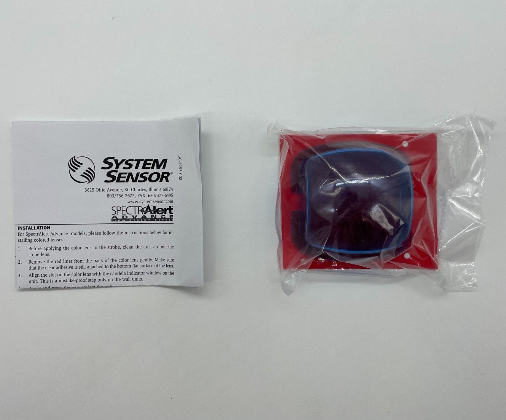 Blue lens attachment for System Sensor wall strobe light, enhancing visibility and focus for security and emergency signaling.
