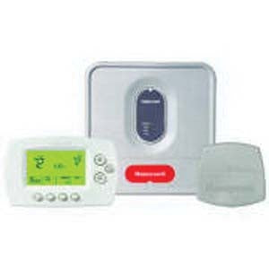 Resideo Honeywell Home YTH6320R1001/U thermostat with equipment module mounted on a wall, showing digital display and control buttons.