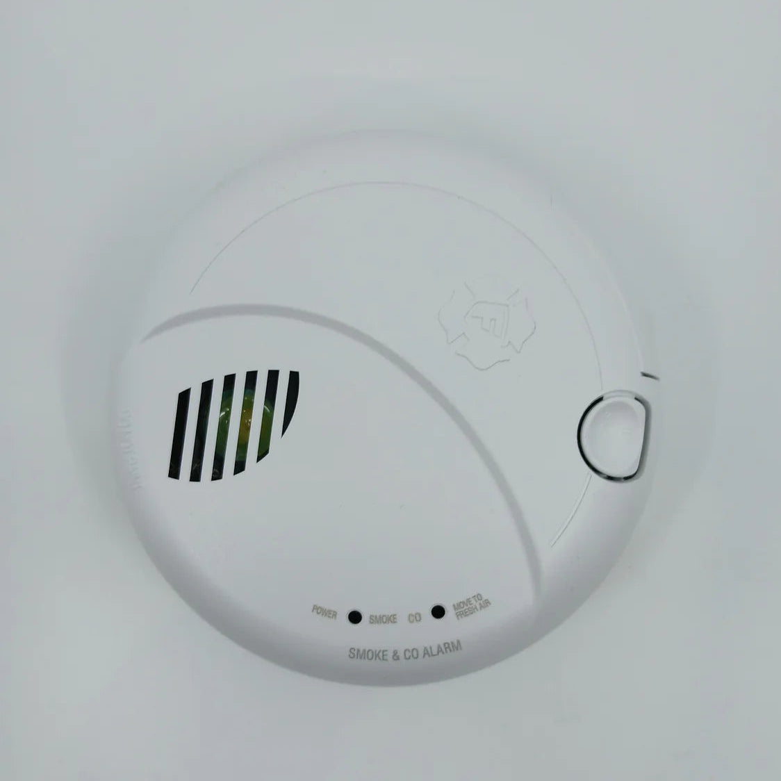 BRK SMCO100V-AC interconnect hardwire smoke and carbon monoxide alarm mounted on wall, with digital display and test button.