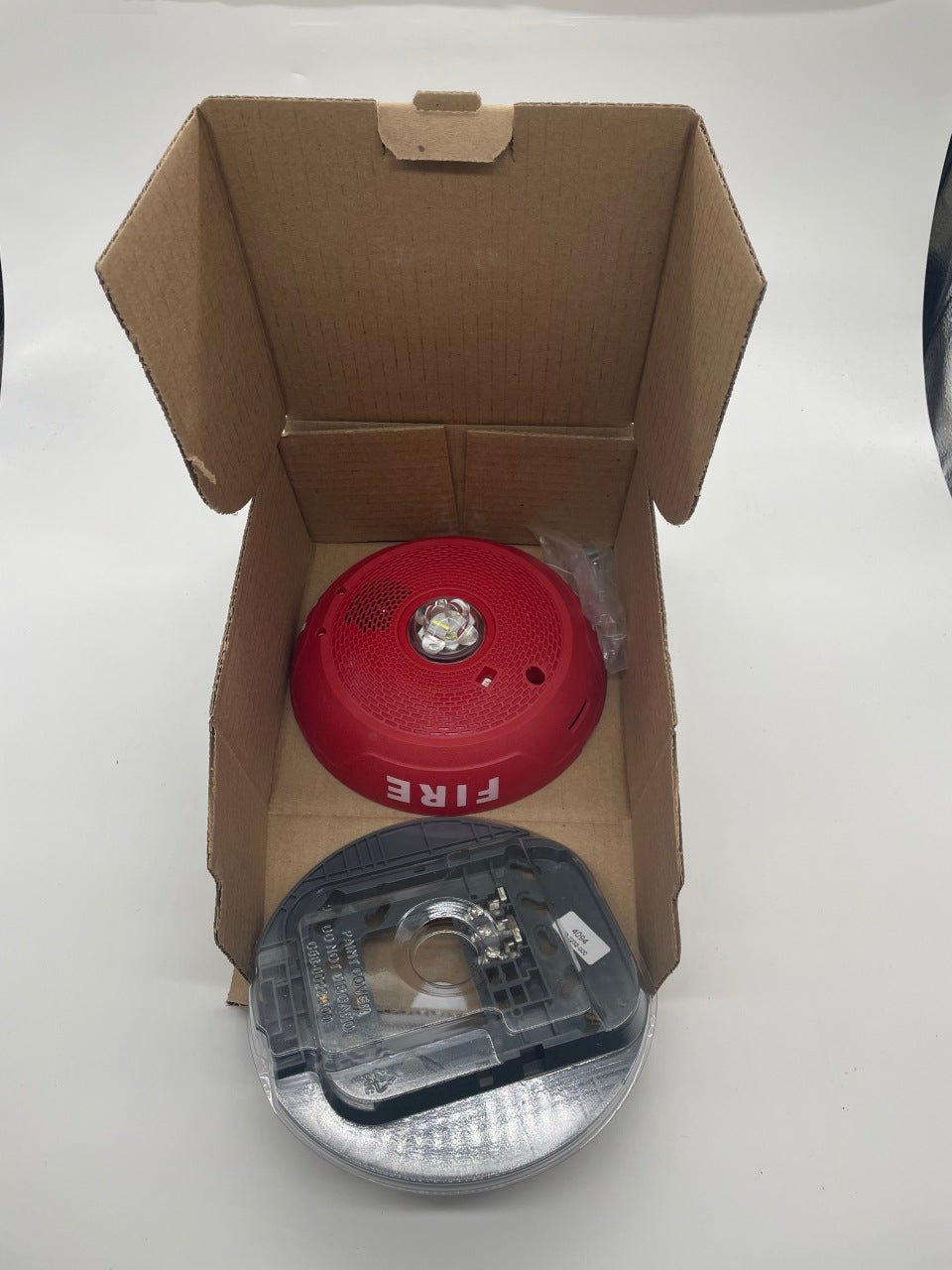 Red System Sensor CHSCRLED chime strobe alarm with integrated light and sound for fire safety and alert signaling.