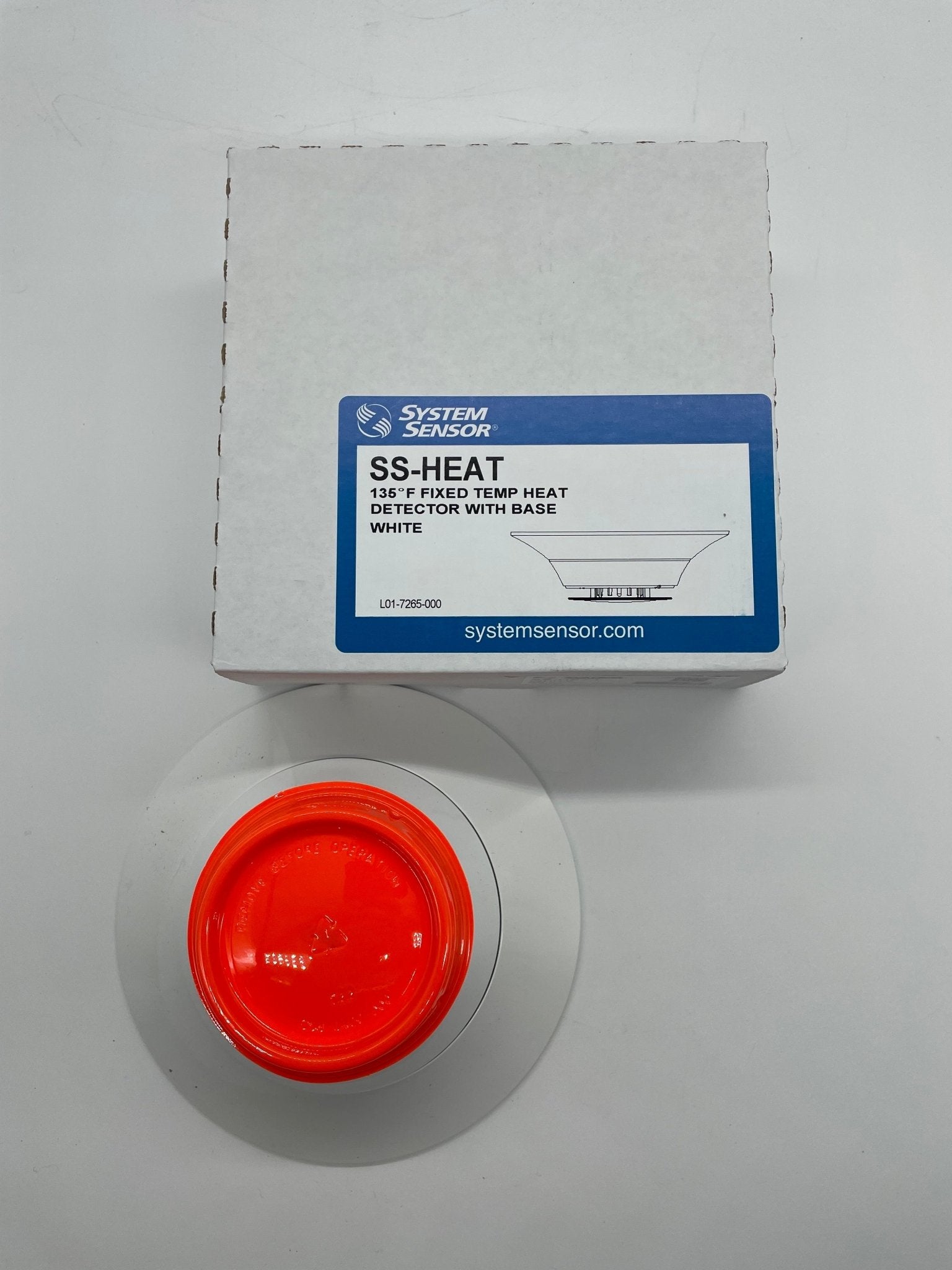 System Sensor SS-HEAT fixed thermal detector for fire safety, showing its compact design and mounting feature.