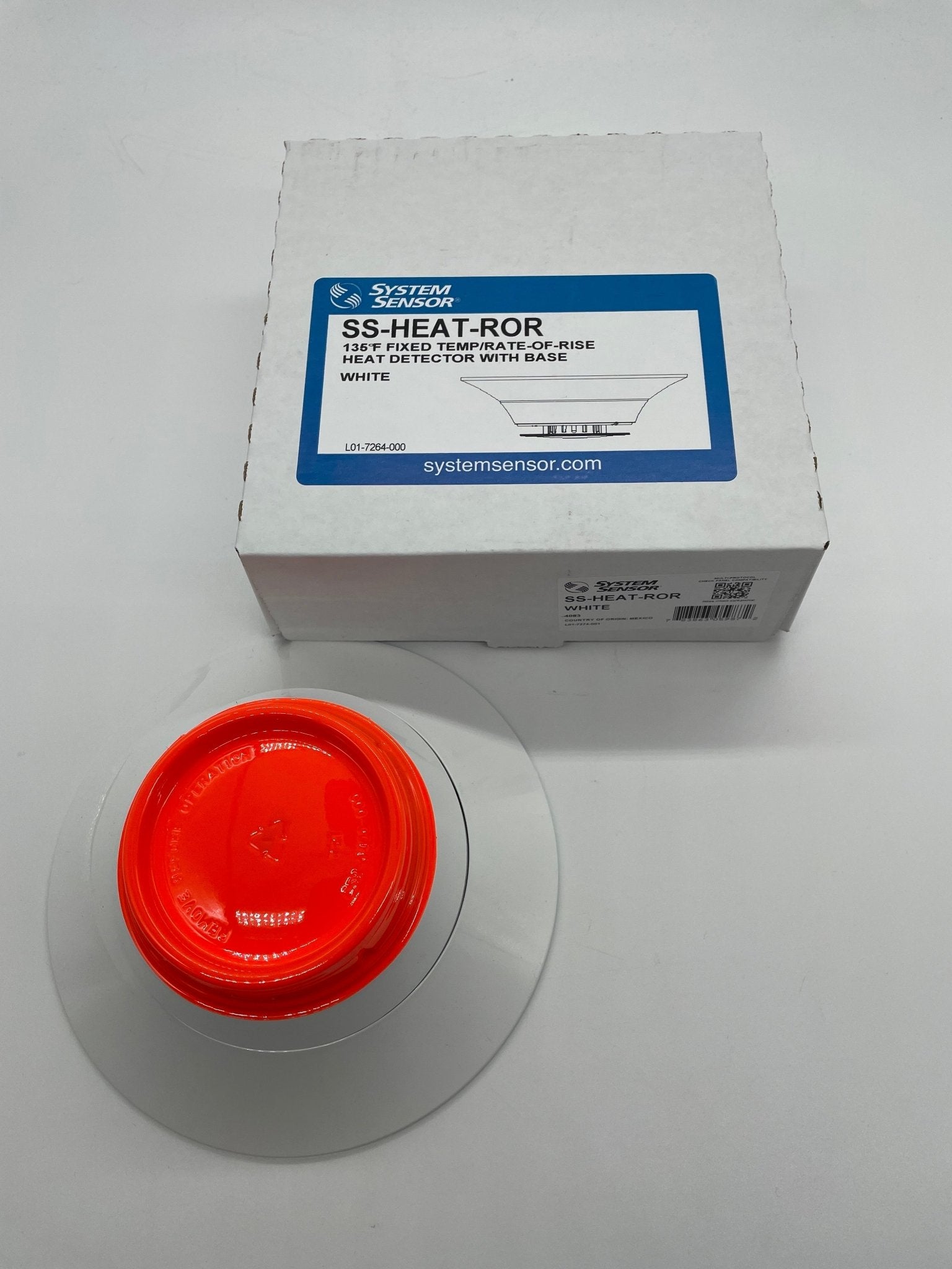 System Sensor SS-HEAT-ROR thermal detector showing a compact black sensor with mounting base for fire detection systems.