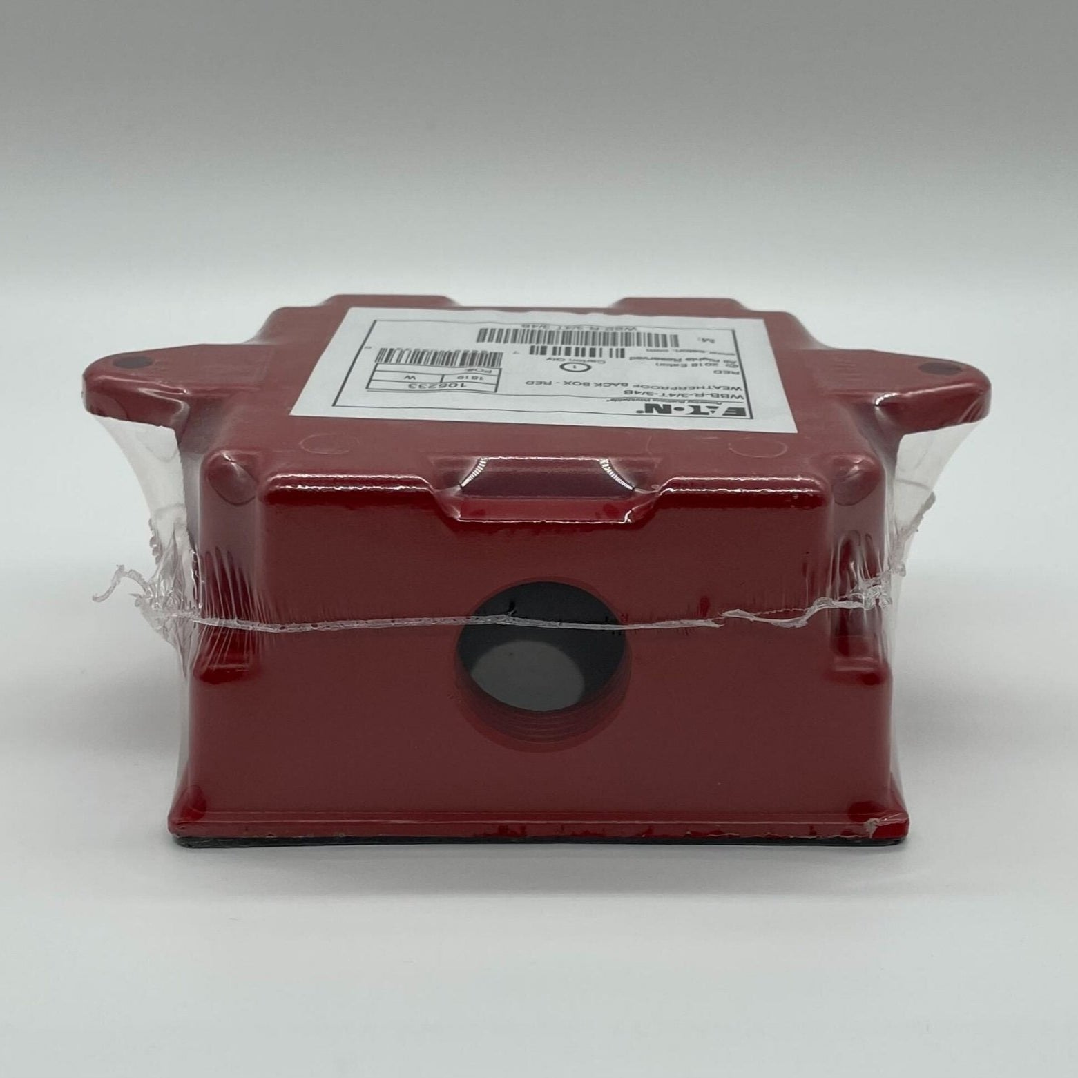 Eaton Wheelock WBB-R-3/4T-3/4B backbox showing metal enclosure with mounting holes for electrical installations.