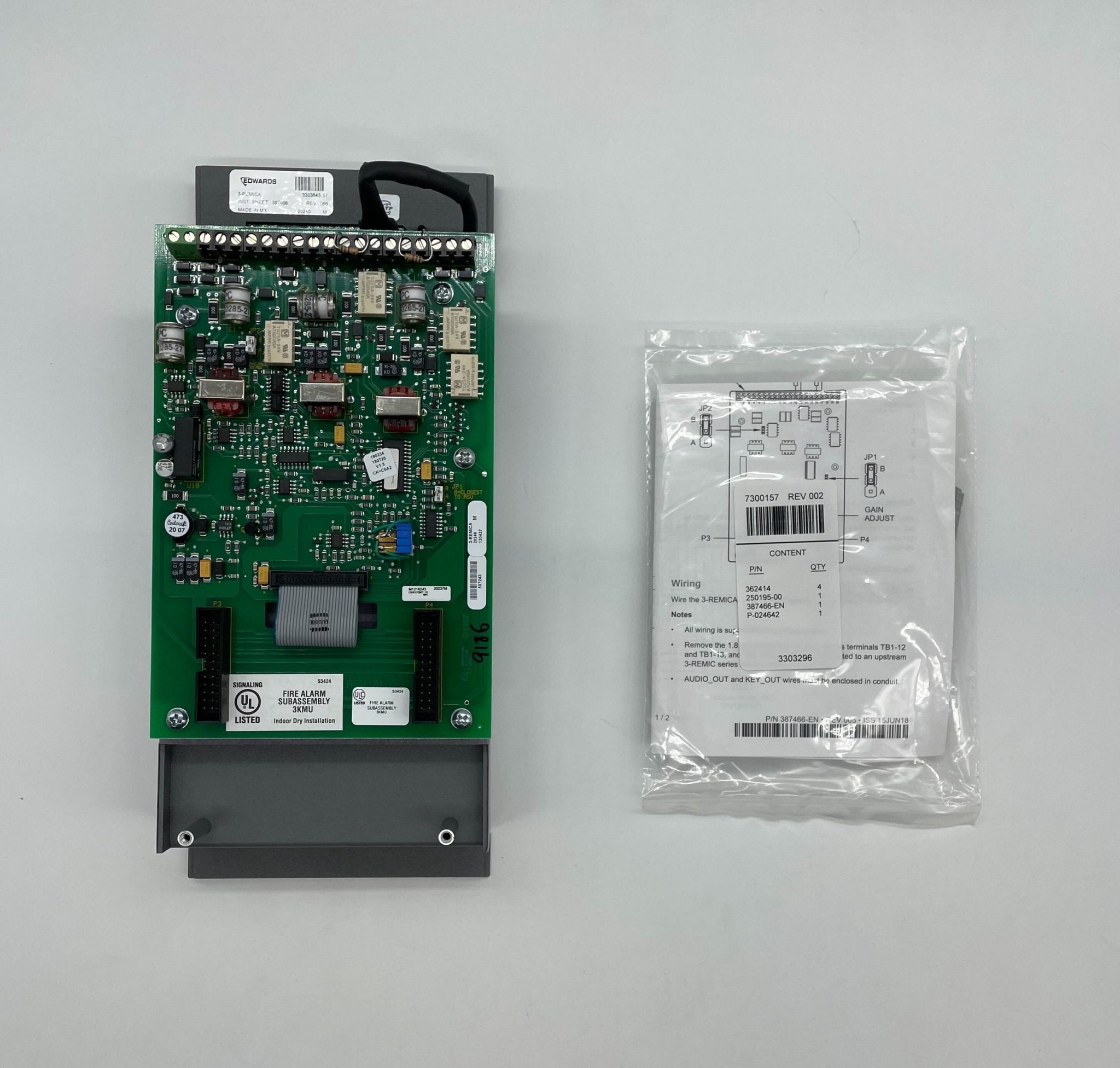 Edwards 3-REMICA fire alarm with digital display and alarm indicators, mounted on a wall for safety monitoring.