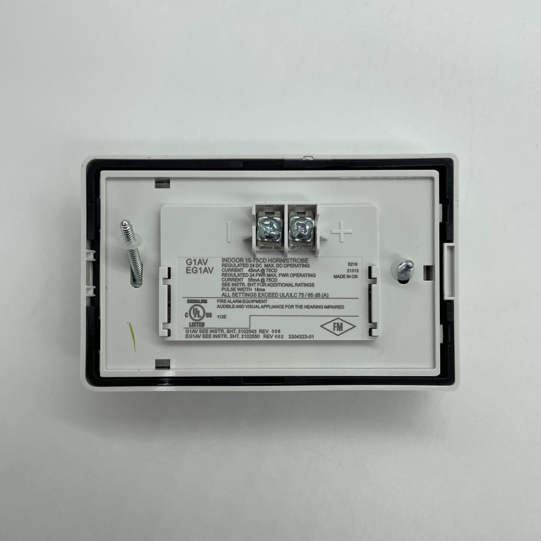 Edwards G1AVWN Compact Wall Horn Strobe mounted on wall, white plastic housing with horn and strobe light for fire alarm signaling