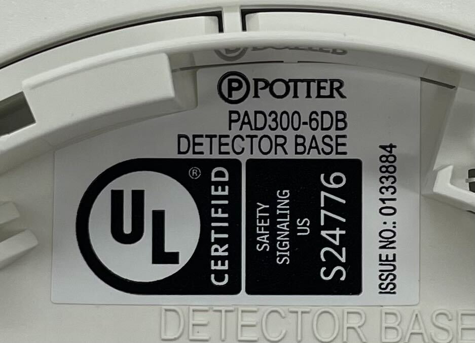 Potter PAD300-6DB 6-inch detector base used for mounting fire alarm detectors, shown in a neutral setting with mounting holes visible.