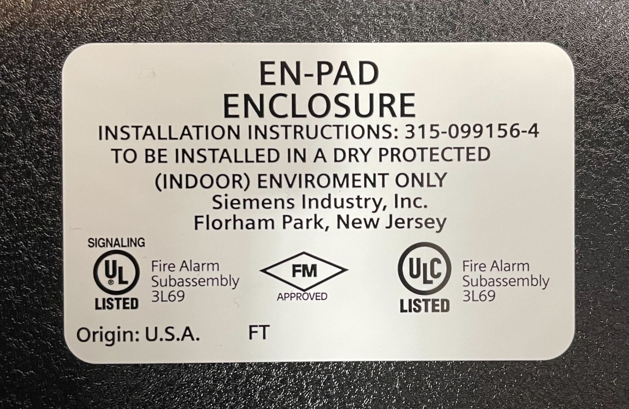 Black Siemens EN-PAD enclosure for PAD-3 fire alarm system, sturdy plastic housing with secure mounting options.
