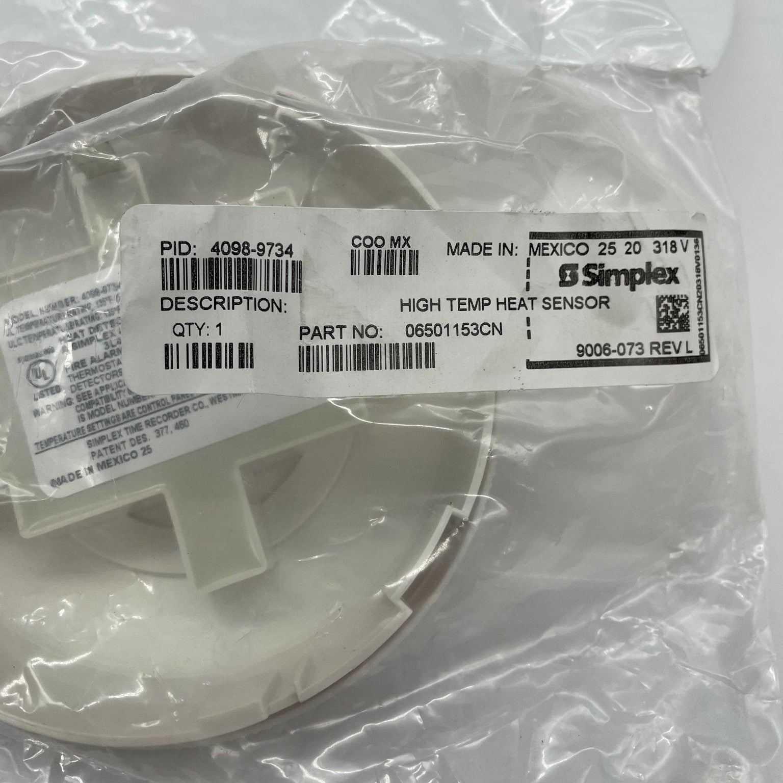 Simplex 4098-9734 high temperature heat sensor in white, a heat detector for fire safety applications.