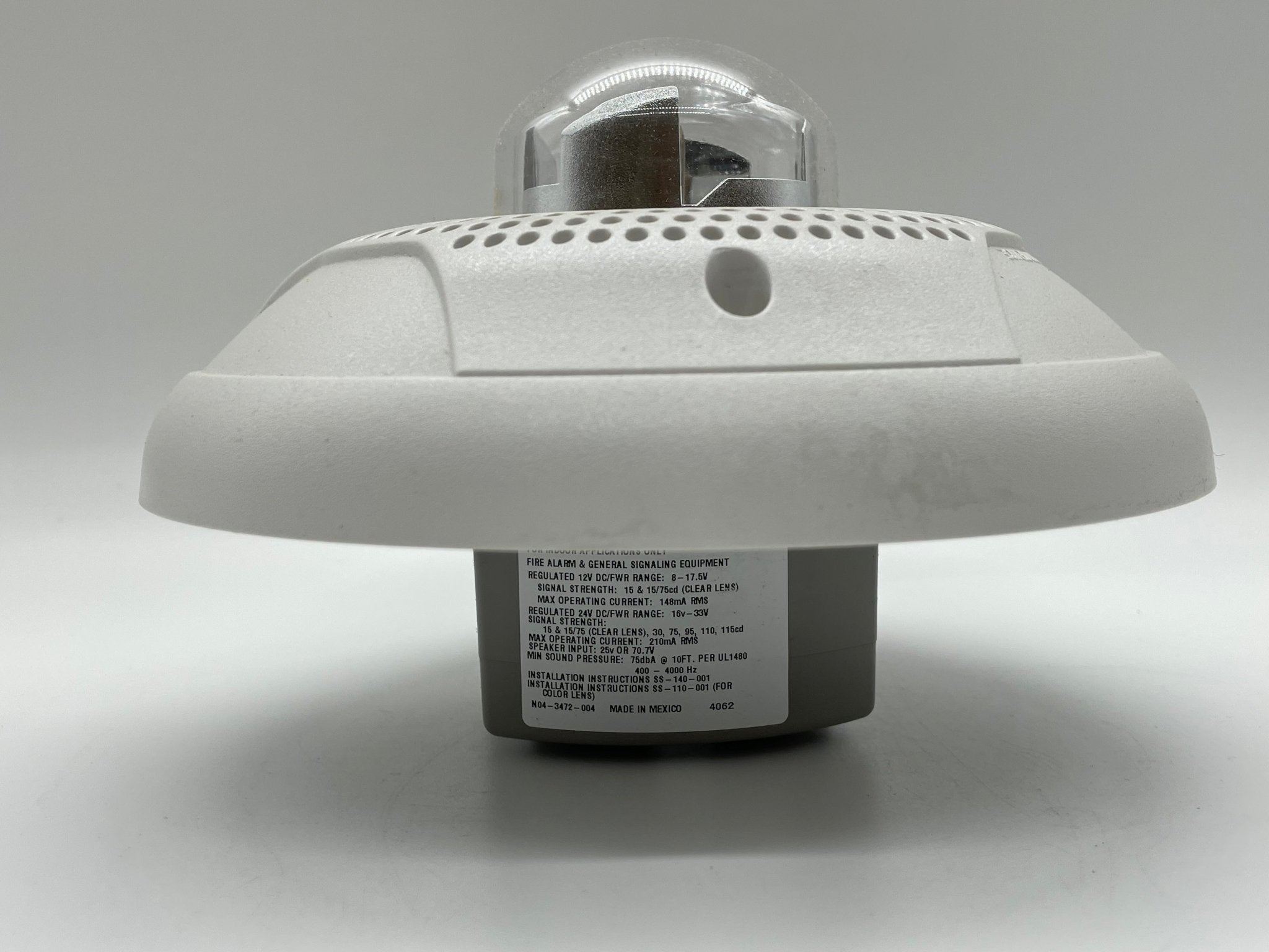 System Sensor PC4W Horn Strobe mounted on wall, warning device with flashing light and loud horn for fire alarm signaling.