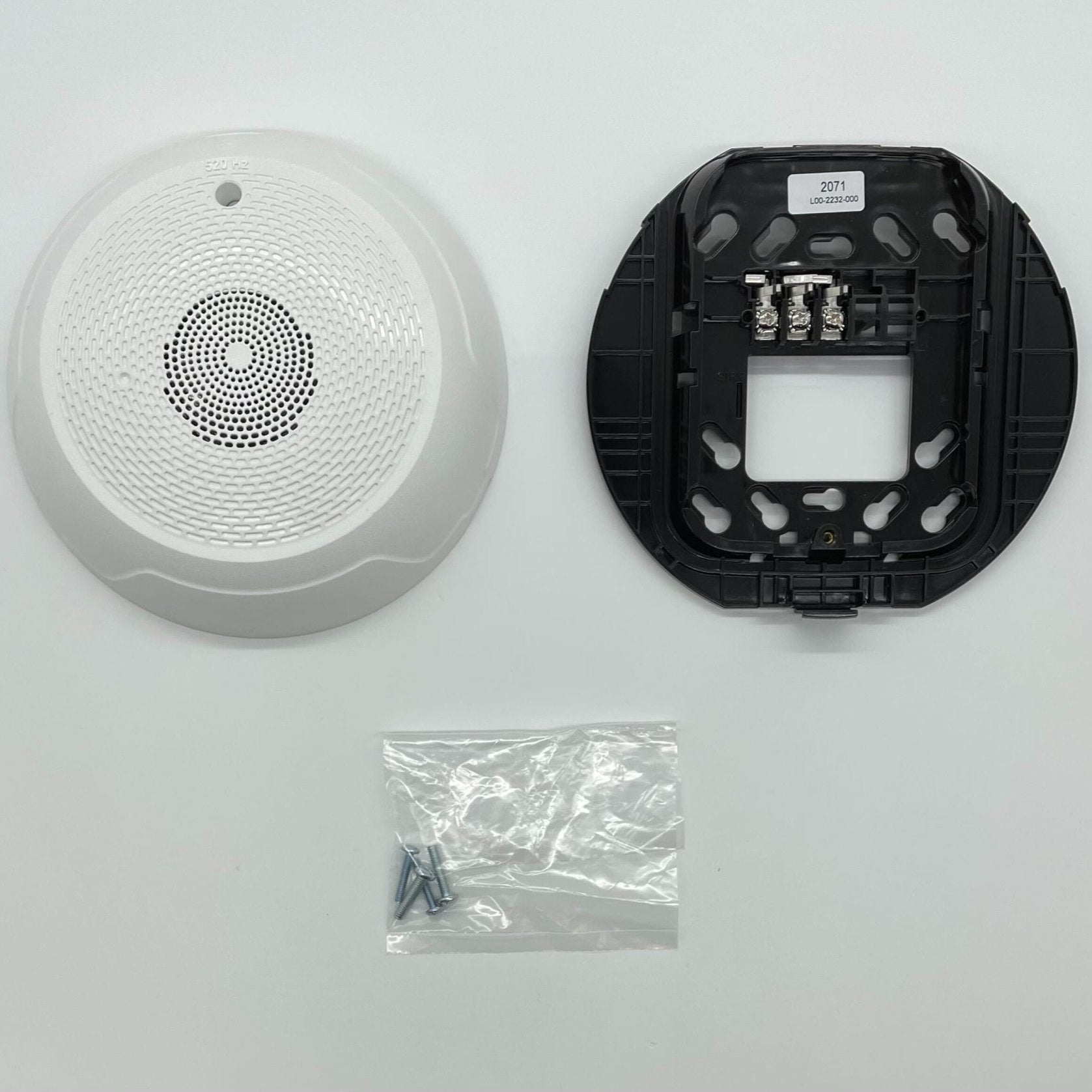 System Sensor HCWL-LF low-frequency compact sounder mounted on a wall, showing its cylindrical design and mounting bracket.