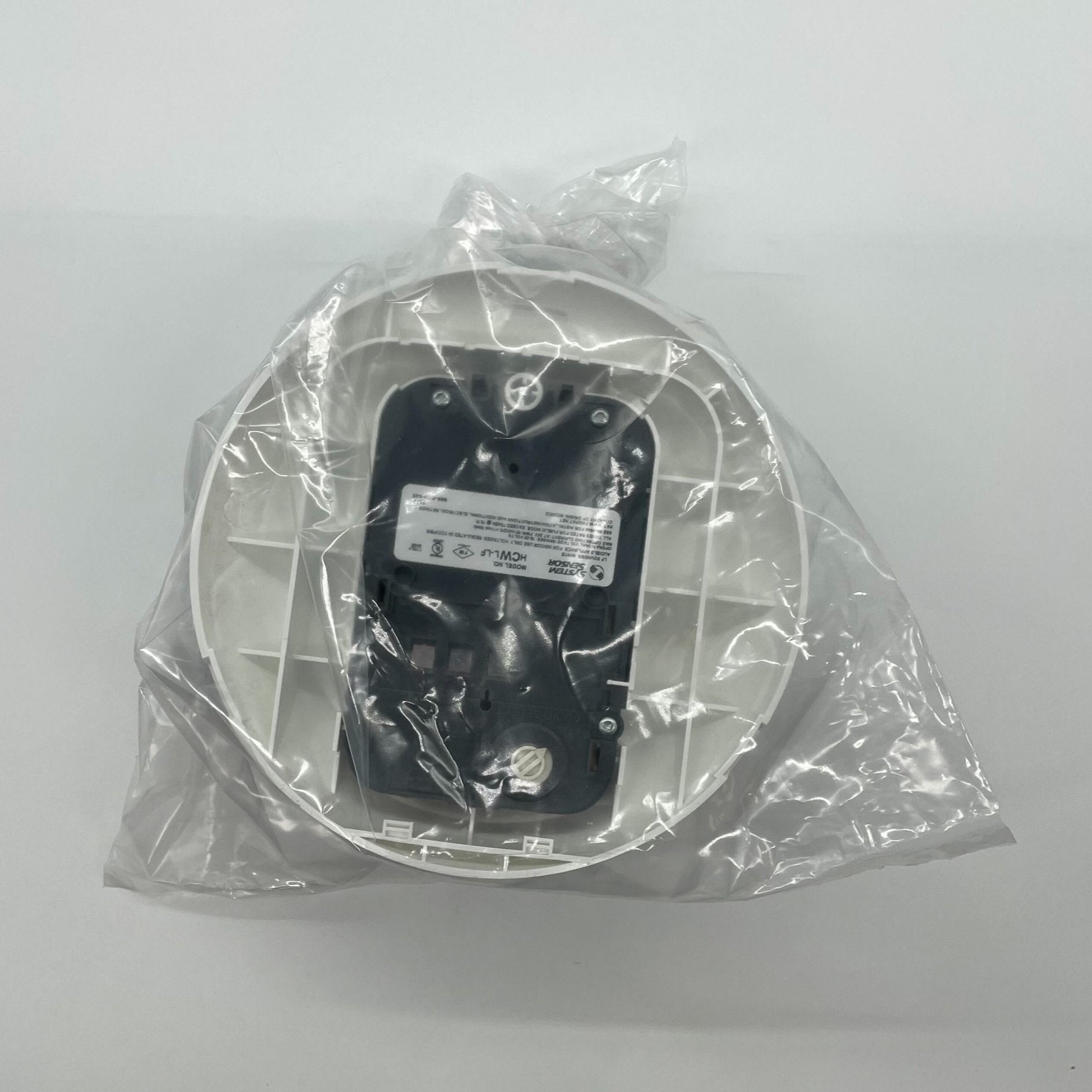 System Sensor HCWL-LF low-frequency compact sounder for alarm systems, showing the small, durable alarm device with mounting features.